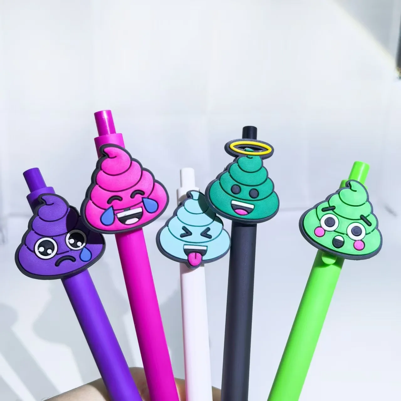

10PCS quirky poop-shaped ballpoint pens. Colorful poop cartoon cute PVC soft rubber stickers. The style is random.