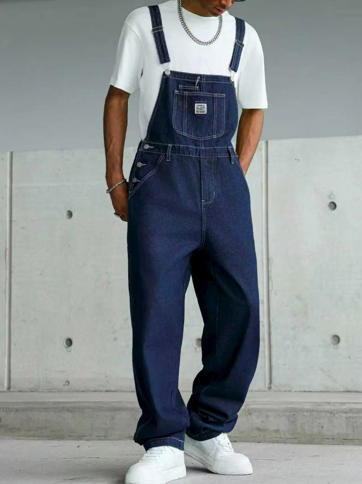 High-quality blue washed multi-pocket denim cargo pants with adjustable shoulder straps, perfect for casual wear in all seasons.