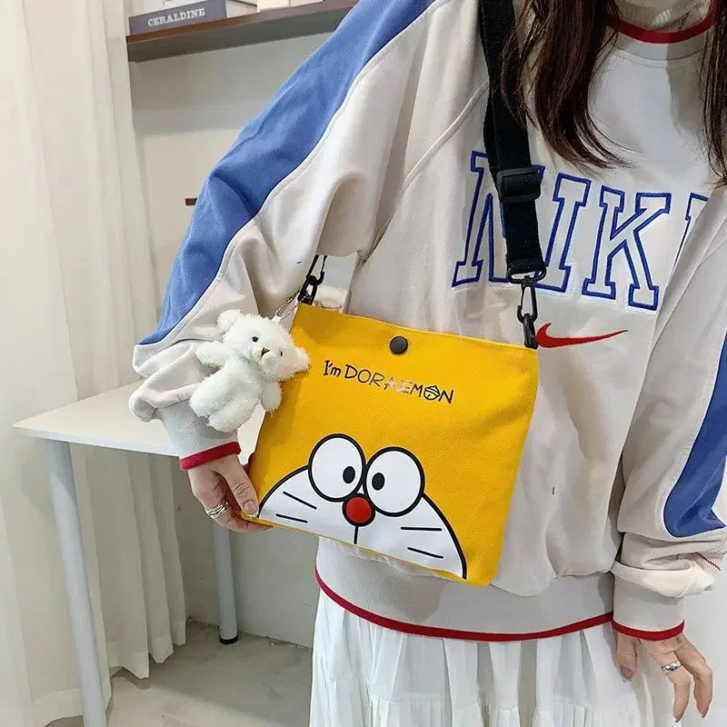 Bolsa pequeña de lona con estampado de dibujos animados de Doraemon, bolso de hombro de gato robot lindo, bolso cruzado de anime Popular, bolsa de almacenamiento de papelería, regalo