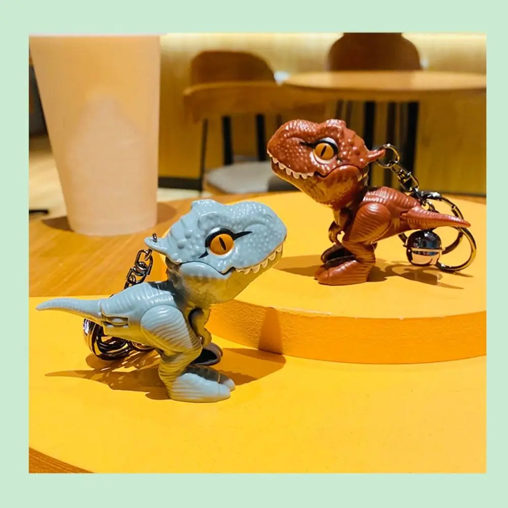 漫画恐竜ティラノサウルスレックス人形キーホルダー手を噛む恐竜の手を噛む恐竜キーリングファッションプラスチック
