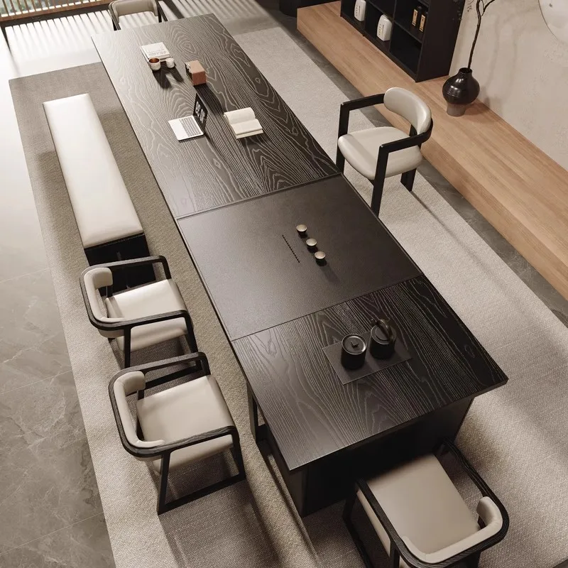 The black  table and chairs are combined, with a  tray and kettle as one