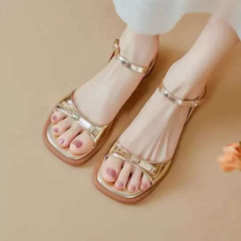 Bow shaped buckle strap sandals for women with flat soles and thick heels. 2024 Summer New Versatile Fashion Gold Silver