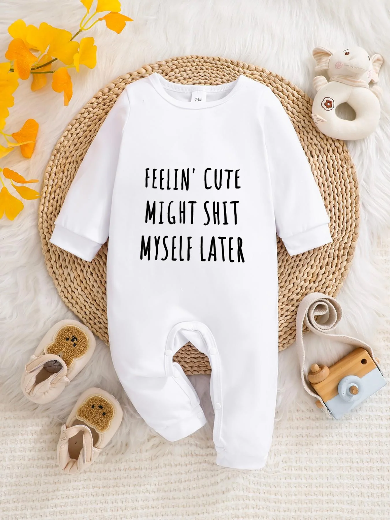 A baby long-sleeved onesie with interesting letter prints. It features a buttoned design for easy putting on and taking off, and