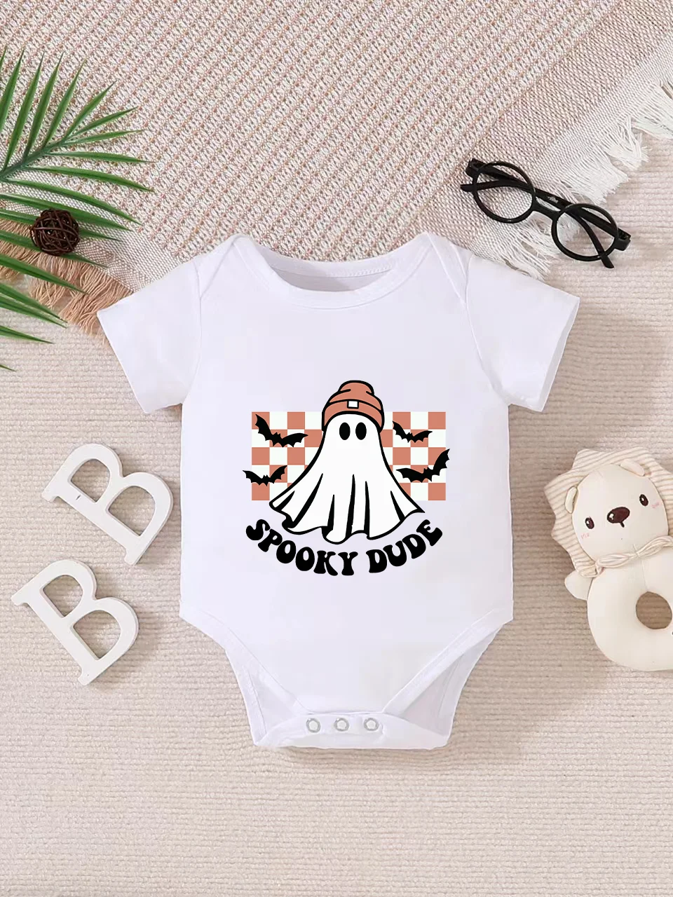 Playful letter-printed baby short-sleeve triangle bodysuit. Button closure for easy dressing, machine washable