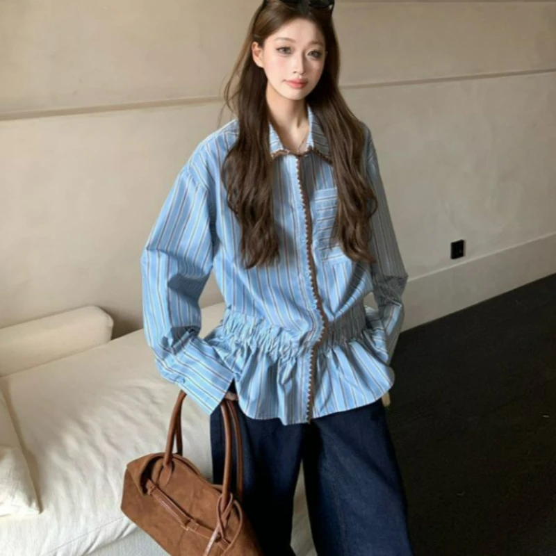 

The 2026 Autumn New American Retro Color-blocking Striped Shirt for Women Wear Is Loose Versatile Niche Blue Long-sleeved Shirt