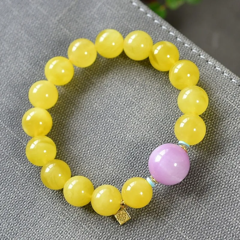 Natural Russian bracelet with a single strand of amber beads featuring a 12mm purple lithium feldspar bead made from raw