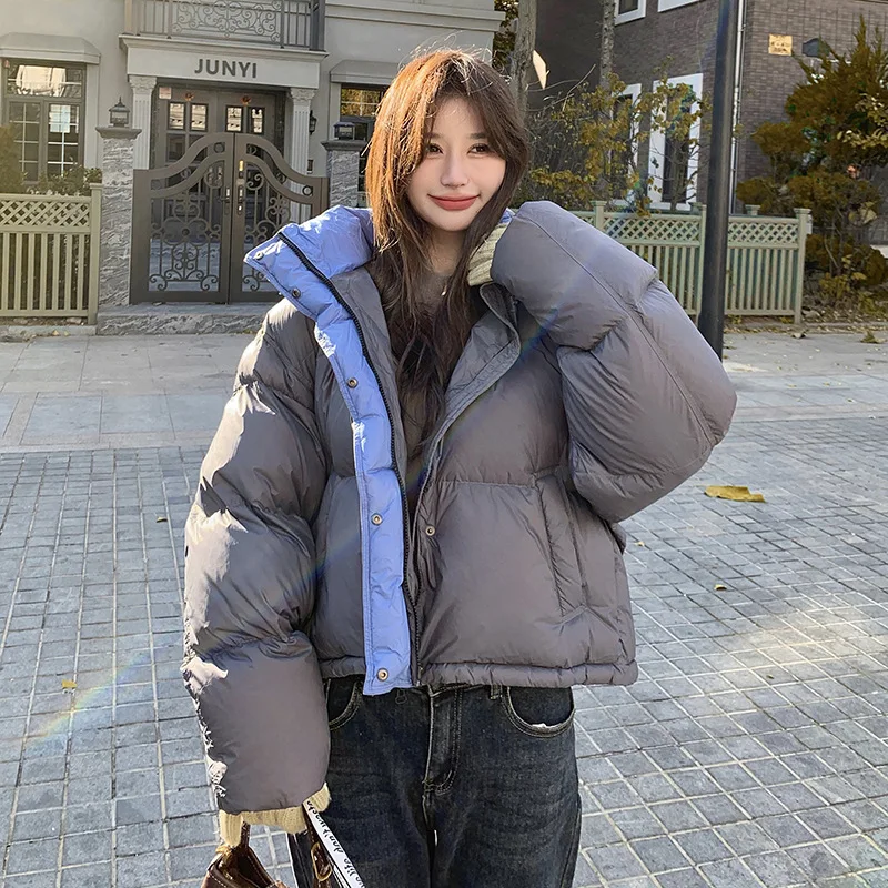Kurtka puchowa damska z kapturem, blokowana kolorystycznie, zimowa 2025, nowa koreańska wersja, luźny krój, gruba i ciepła, uniwersalna kurtka typu chleb.