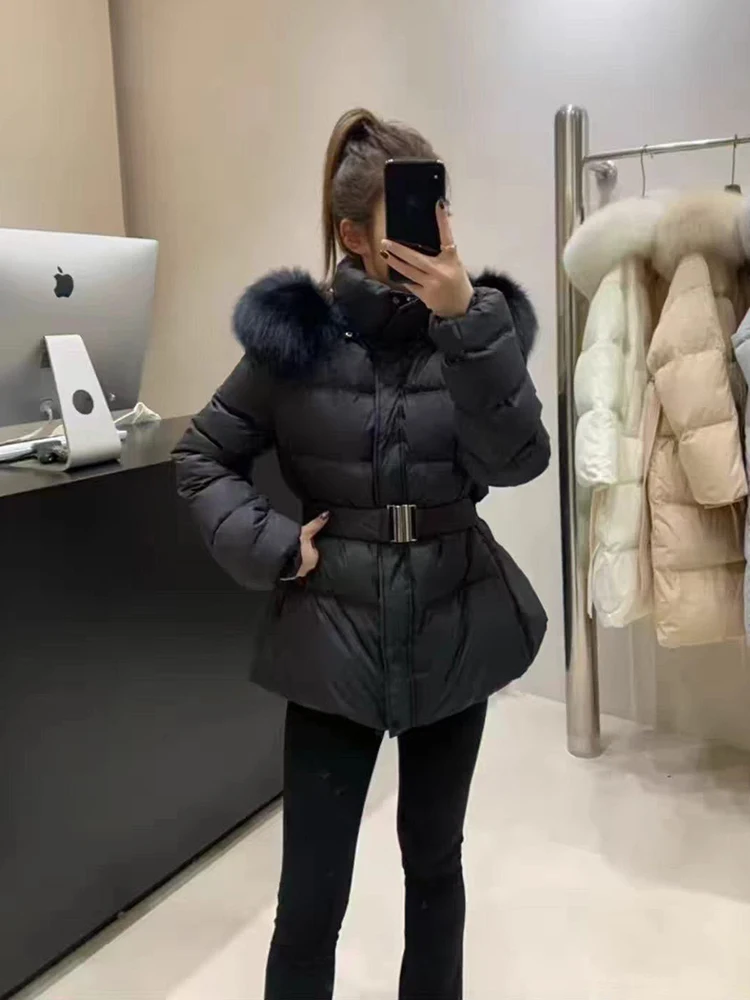 Women's winter short-sleeved down jacket with a wide hood, waist cinching belt and thick padding for warmth and elegant style.