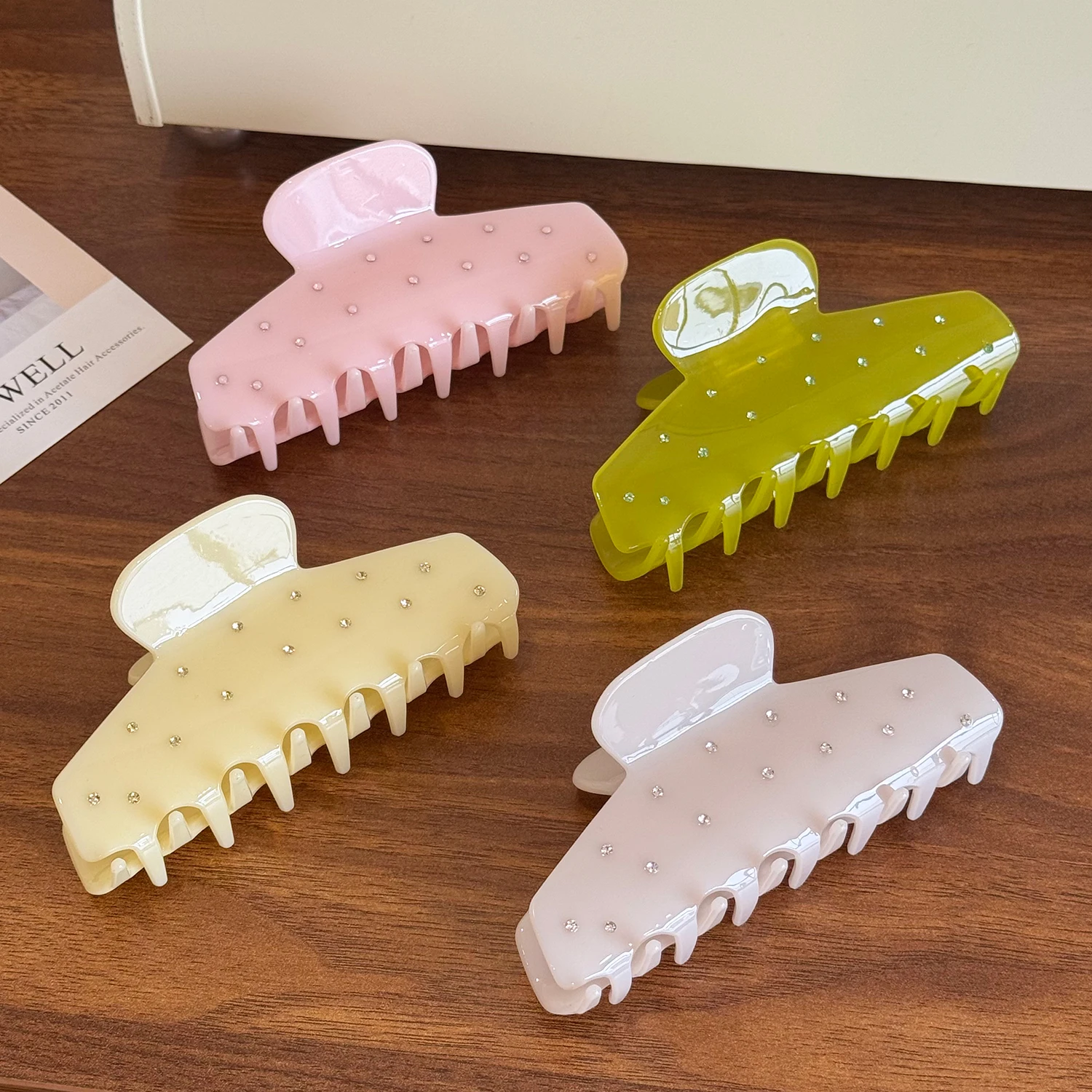 Um versátil grande grampo de cabelo de acetato com agarrador incrustado de diamantes e clipe de tubarão