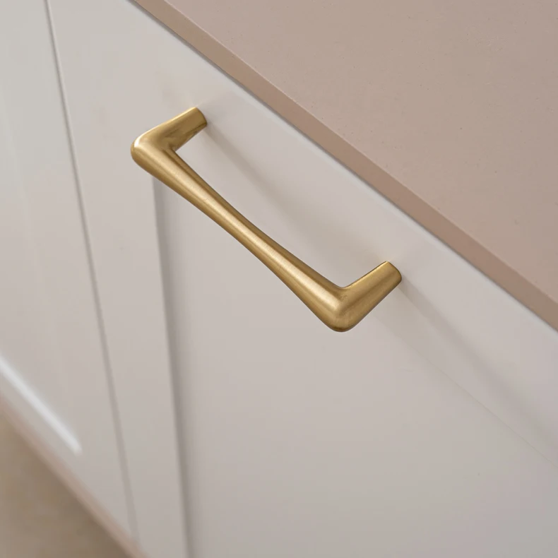 Brass bar handle fitted horizontally to a white drawer