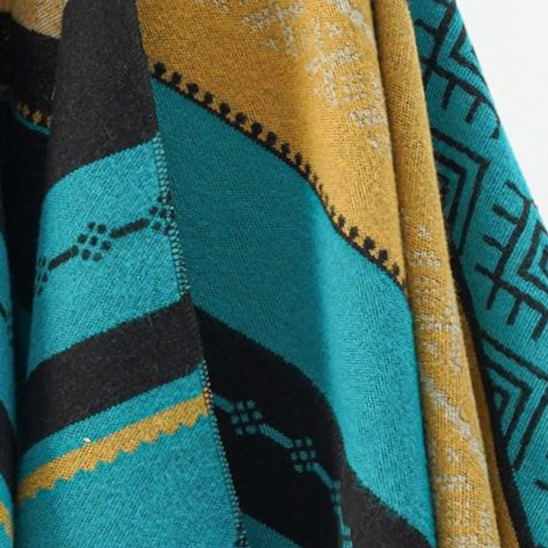 A woman\'s shawl fringed with geometric stripes for casual warmth and cold protection