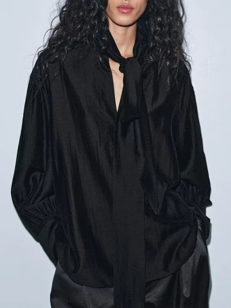 European style new women's fashion versatile elegant solid color long-sleeved shirt with bow detail and round neckline.