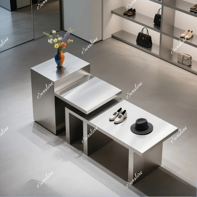 

Stainless steel high and low display table in the middle of the clothing store