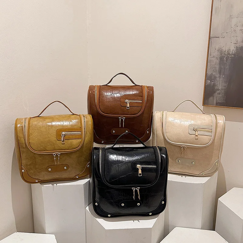 

PU Leather Makeup Bag for Women Large Capacity Versatile Toilet Bag 2026 New Fashionable Handbag Premium Storage Handheld Bags