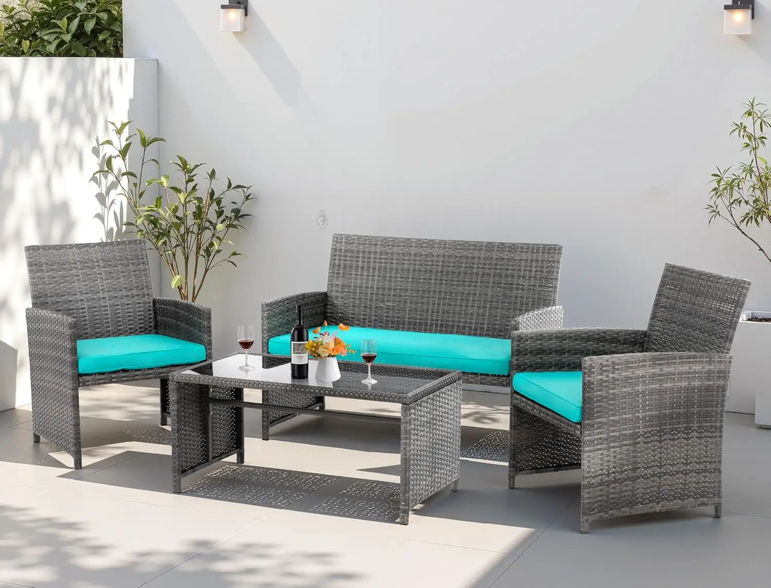 Blue 4-piece rattan wicker outdoor conversation set with soft padded cushions and tempered glass tabletop, multi-person weatherproof leisure furniture for garden and backyard