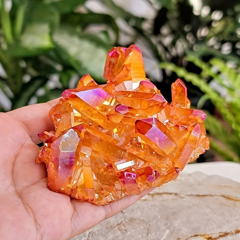 A cluster of orange quartz crystals with a rainbow halo, perfect for crystal collectors.