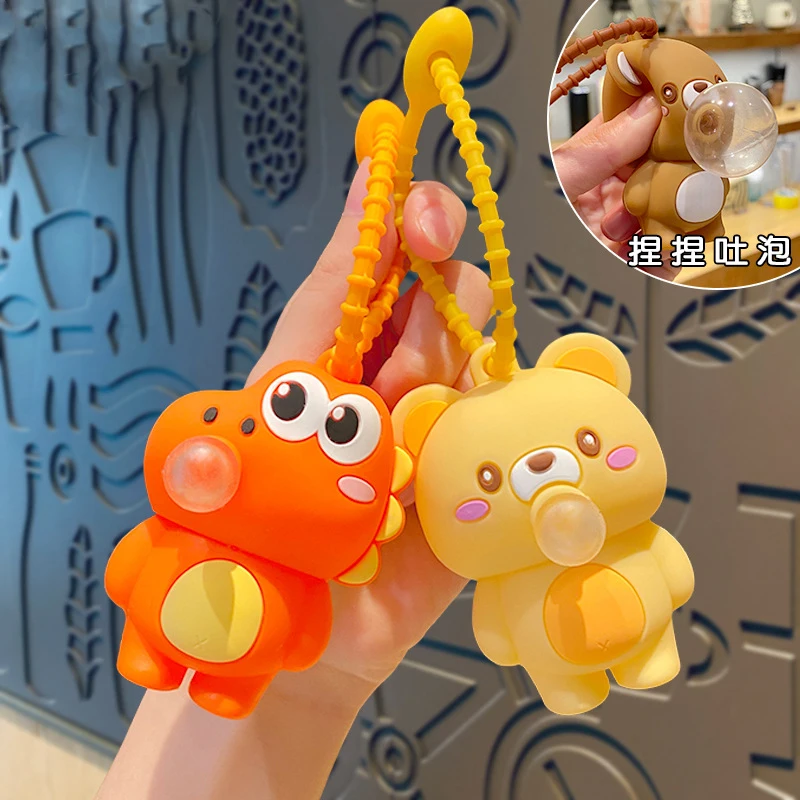 Simpatico morbido Silicone animale orso marrone che soffia bolle portachiavi occhi grandi testa laterale arancione dinosauro giocattolo bambola portachiavi ciondolo borsa