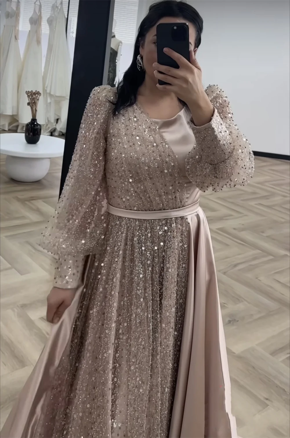 Mina-2024-A woman in a satin dress with long sleeves and sequins, a luxurious evening dress, dressed up for a wedding