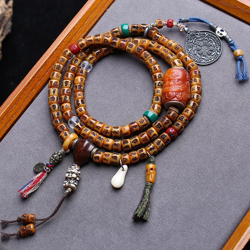 Engraved six-character mantra 108 made of yak bone, yellow wealth god barrel beads, cloud pendant, and copper Bagua access