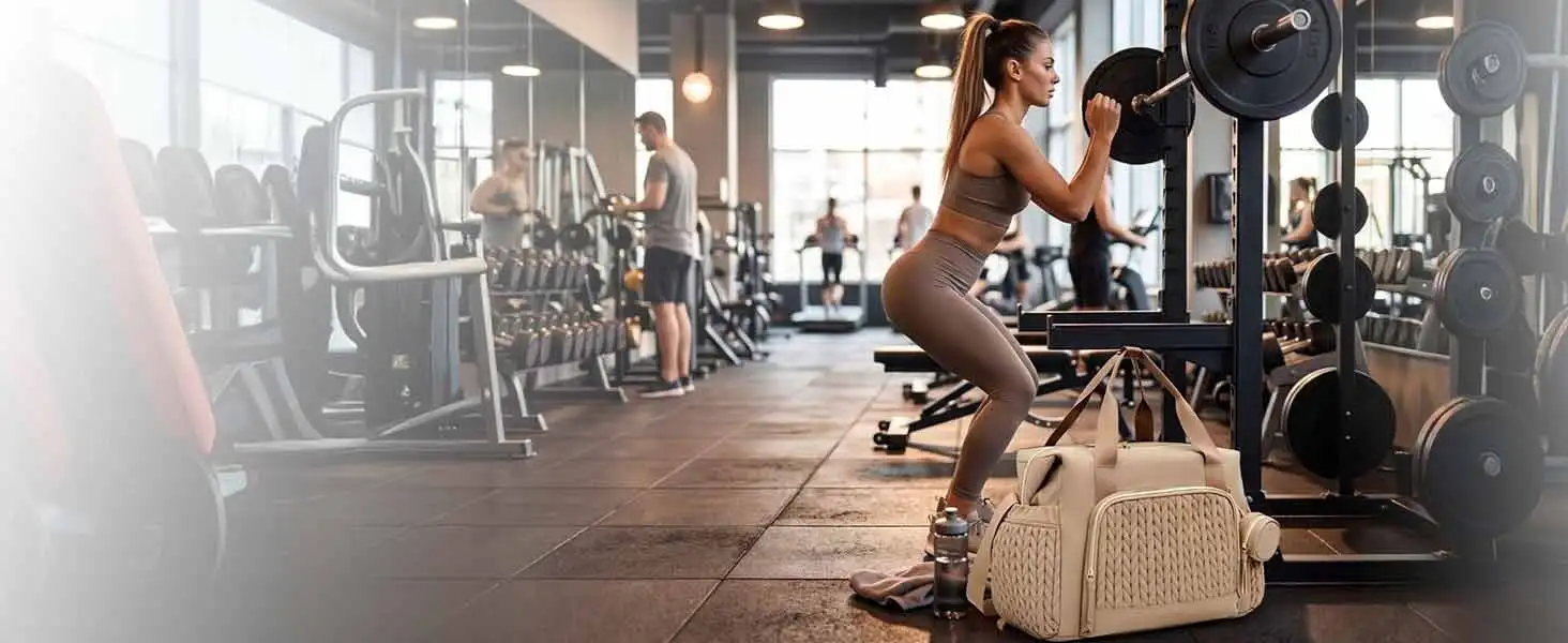 Fitness gym setting showing person in athletic wear performing exercise with equipment visible in blurred gym interior background.