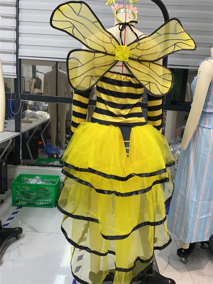 dult women's bumble bee Halloween costume set featuring a yellow and black striped halter-neck dress with a high-low tulle skirt, mesh wings, antenna headband, and matching arm sleeves.