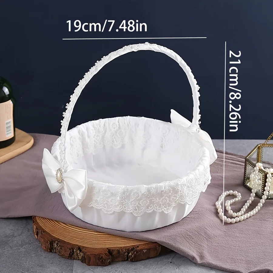 A floral basket with wedding candies, scattering flowers, and a beautiful large bow for the white flower girl.