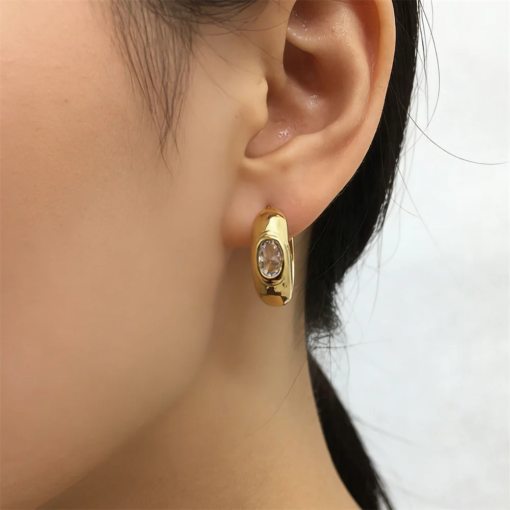 

18K Gold Plated Copper Huggie Earrings with Oval Cubic Zirconia Chunky Polished Hoop Design Minimalist Luxury Jewelry for Women