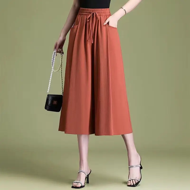 

Женская одежда, новинка лета 2025 года, свободные пригородные брюки-капри с высокой талией, модные эластичные однотонные повседневные широкие брюки с карманами