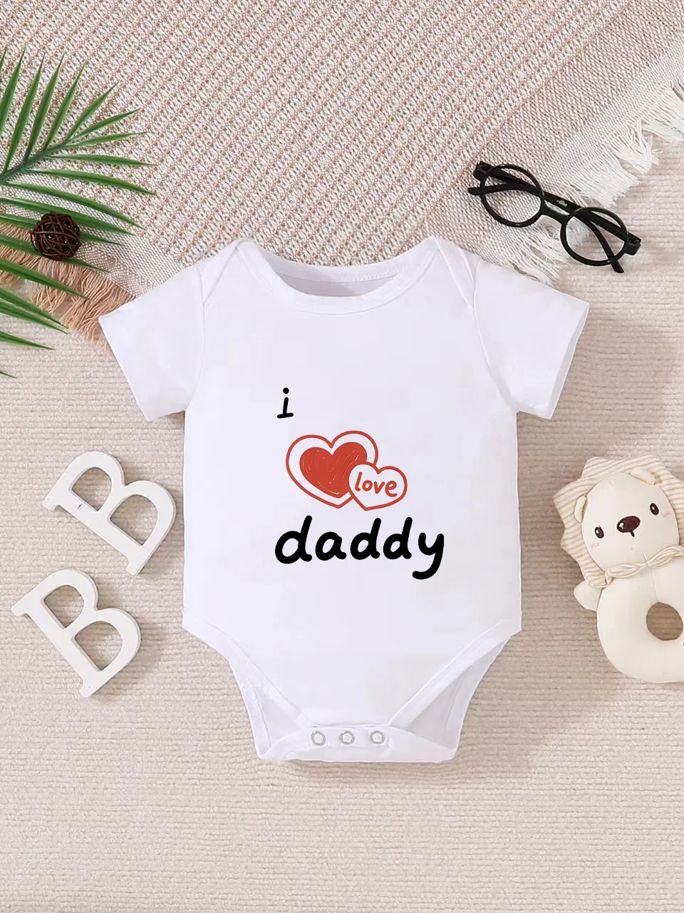 

Playful letter-printed baby short-sleeve triangle bodysuit. Button closure for easy dressing, machine washable