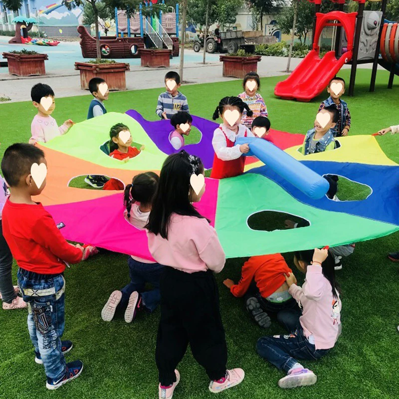 I bambini all'aperto giocano con la tenda del giocattolo dell'arcobaleno del paracadute giochi per bambini parco giochi per l'asilo divertimento delle attività di Team Building della cooperazione