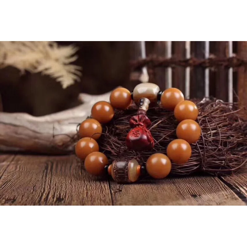Naturally weathered chicken oil yellow round bead bracelet. The Bodhi root has a fine texture and moderate hardness