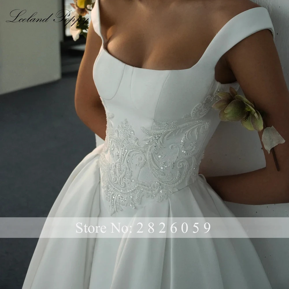 IJsland Poppy op maat gemaakte A-lijn satijnen trouwjurken vloerlengte mouwloze bruidsjurken met parels en kralen en rechtersleep