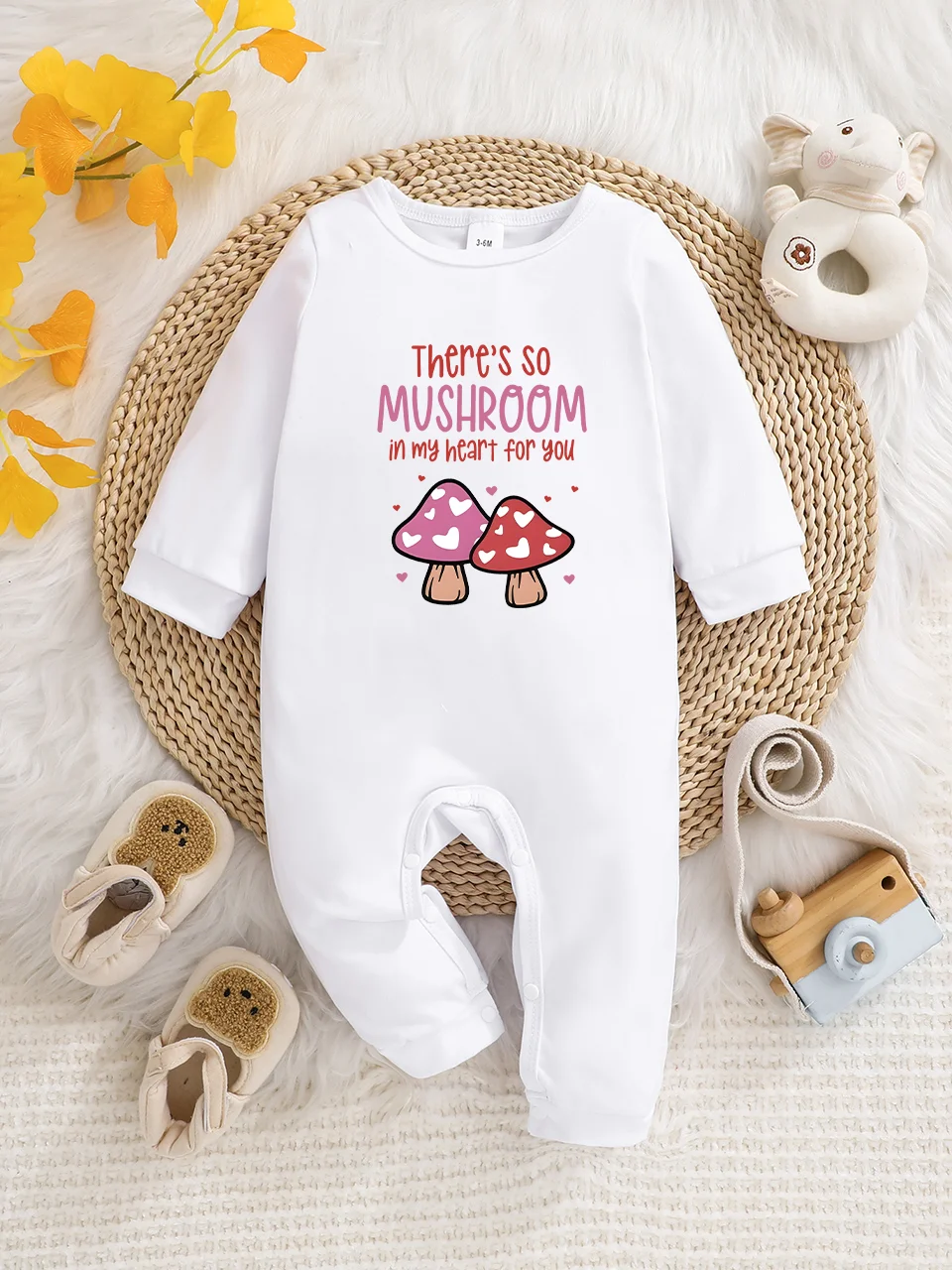 A baby long-sleeved onesie with interesting letter prints. It features a buttoned design for easy putting on and taking off