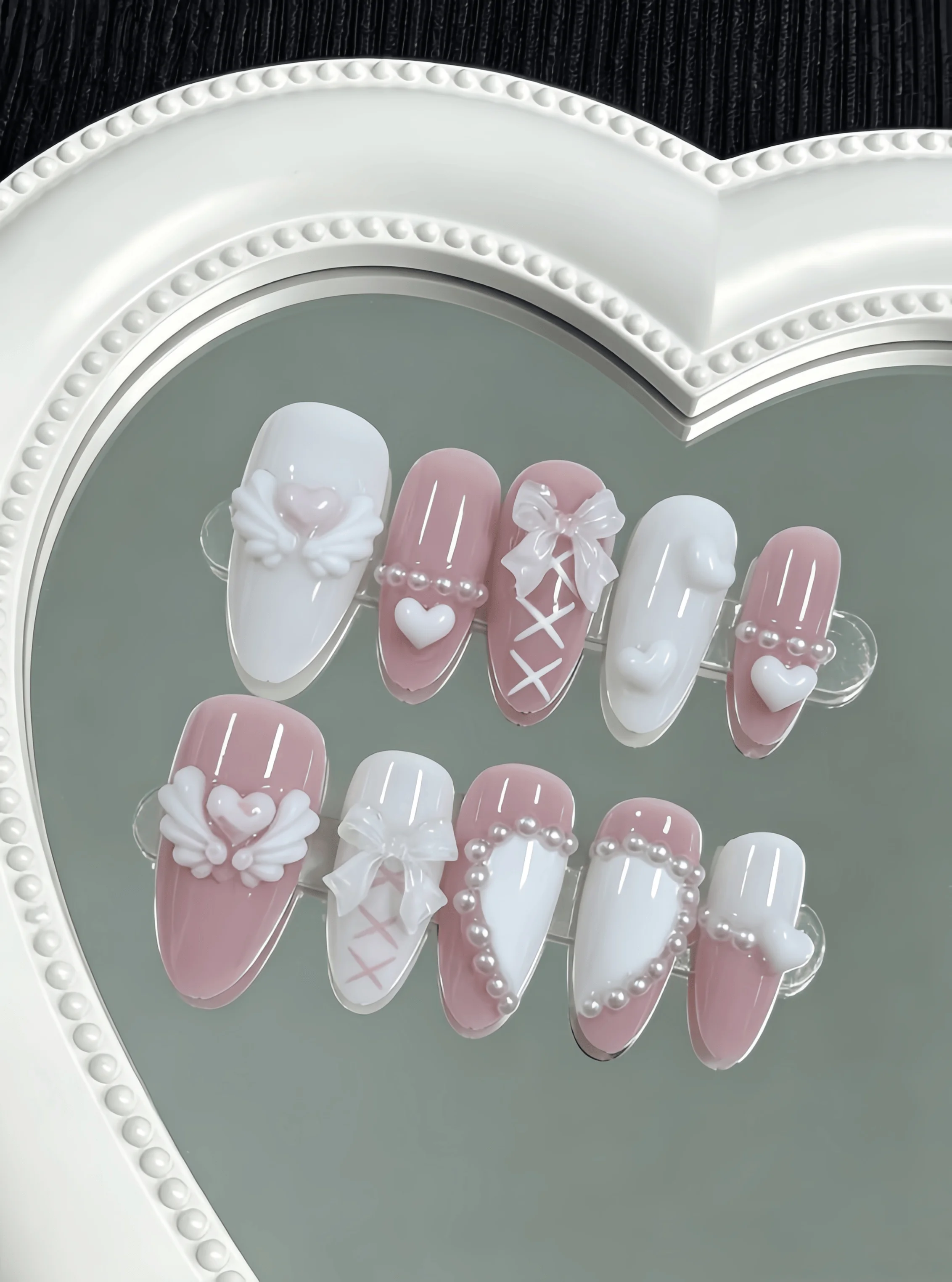 10 Pieces of Handmade Almond-Shaped Full-Cover Nail Tips, Medium Length, with Nude Pink and Milky White Color Scheme, Featuring 3D Heart Wings, Ribbon Bows, Tie Patterns, and Pearl Border Decorations, in a Gentle, Sweet, and Cool Style Suitable for Women and Girls, Perfect for Summer Vacations, Graduation Season, and as a Gift, Comes with 1 Piece of Jelly Glue and 1 Nail File