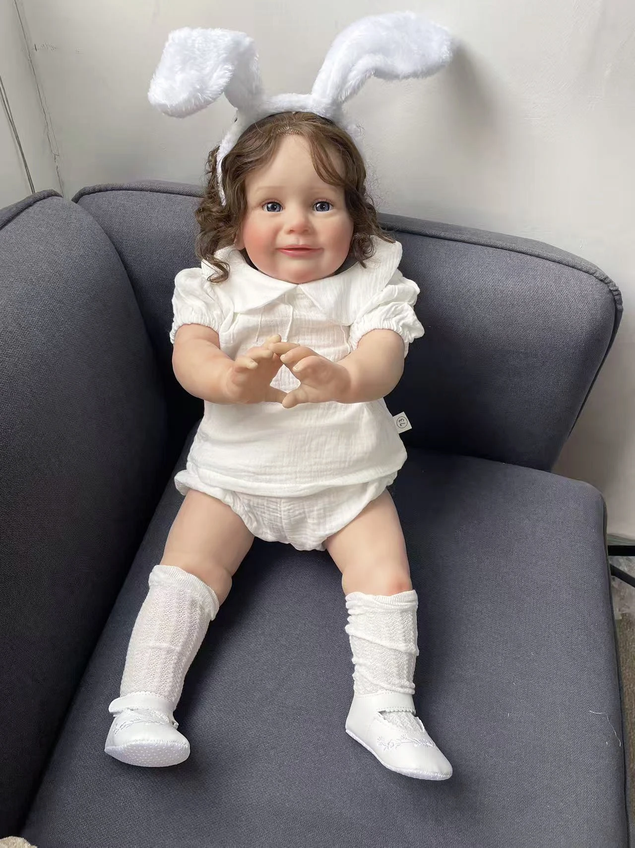 25Inch Hand Root Hair Zoe Wearing A White Short Sleeved Clothing Set and White Rabbit Ear Headband Lifelike Cute Reborn Doll