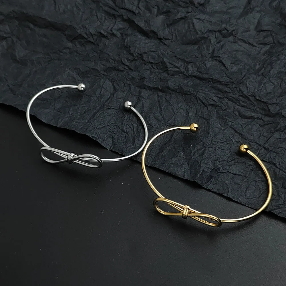 

Creative steel wire button pattern bow gold-plated stainless steel bracelet, waterproof and rust-free, couple bracelet
