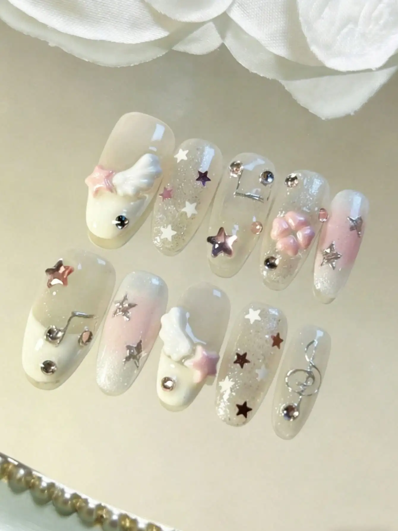 

10 piece handmade oval nail stickers, Y2K style gradient pink and white, 3D wings, stars, notes, diamond stickers