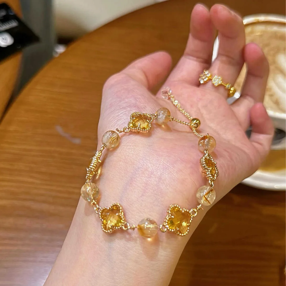 

Lucky four-leaf clover bracelet with gold-tone crystal adjustable chain, perfect for anniversaries or Valentine's Day gifts.