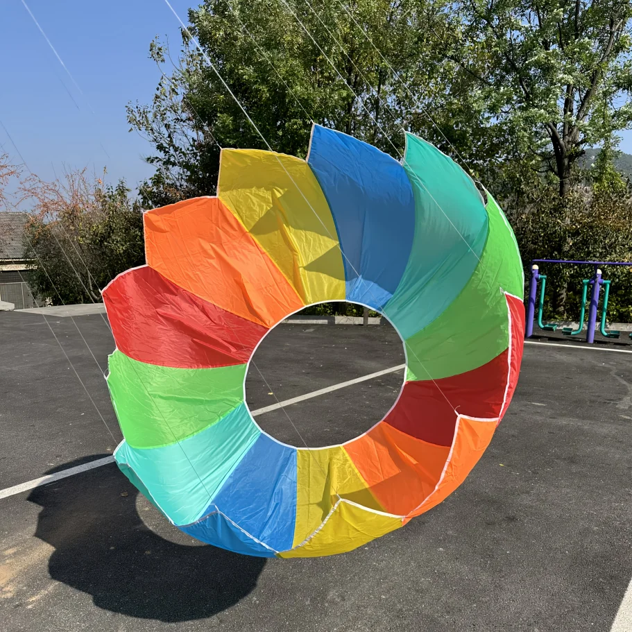 Outdoor hand pulled rolling dragon kite, adult spinning soft rainbow kite, beach park camping and flying view 6