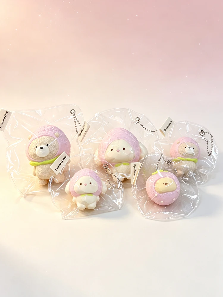Handmade stress-relief squishies: a bear, a rabbit, and a mouse wearing strawberry hats.