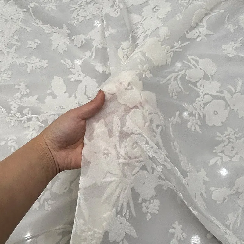 This is a light luxury dress and cheongsam fabric made of single-color patterns as well hollowed-out burned