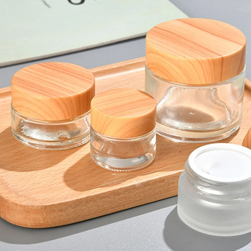 Frascos redondos de vidrio transparente vacíos con tapas de madera, botella de viaje, contenedor de almacenamiento de muestras de crema de loción, 5/10/15/20/30/50/60g, venta al por mayor