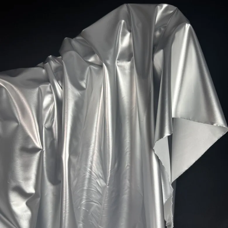 

Glossy shiny faux leather fabric, silky metallic silver film down jacket fabric, designer coat material sold by the meter