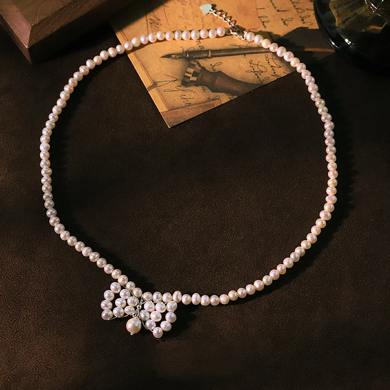 

Оригинальное ожерелье с бантом из натурального жемчуга для женщин, шейная цепочка во французском стиле, белые бусины, колье-воротник, модные ювелирные изделия, подарочный аксессуар