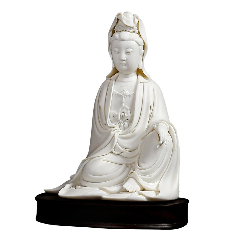 Ceramic Guanyin statue white porcelain carving artwork sits on Guanyin