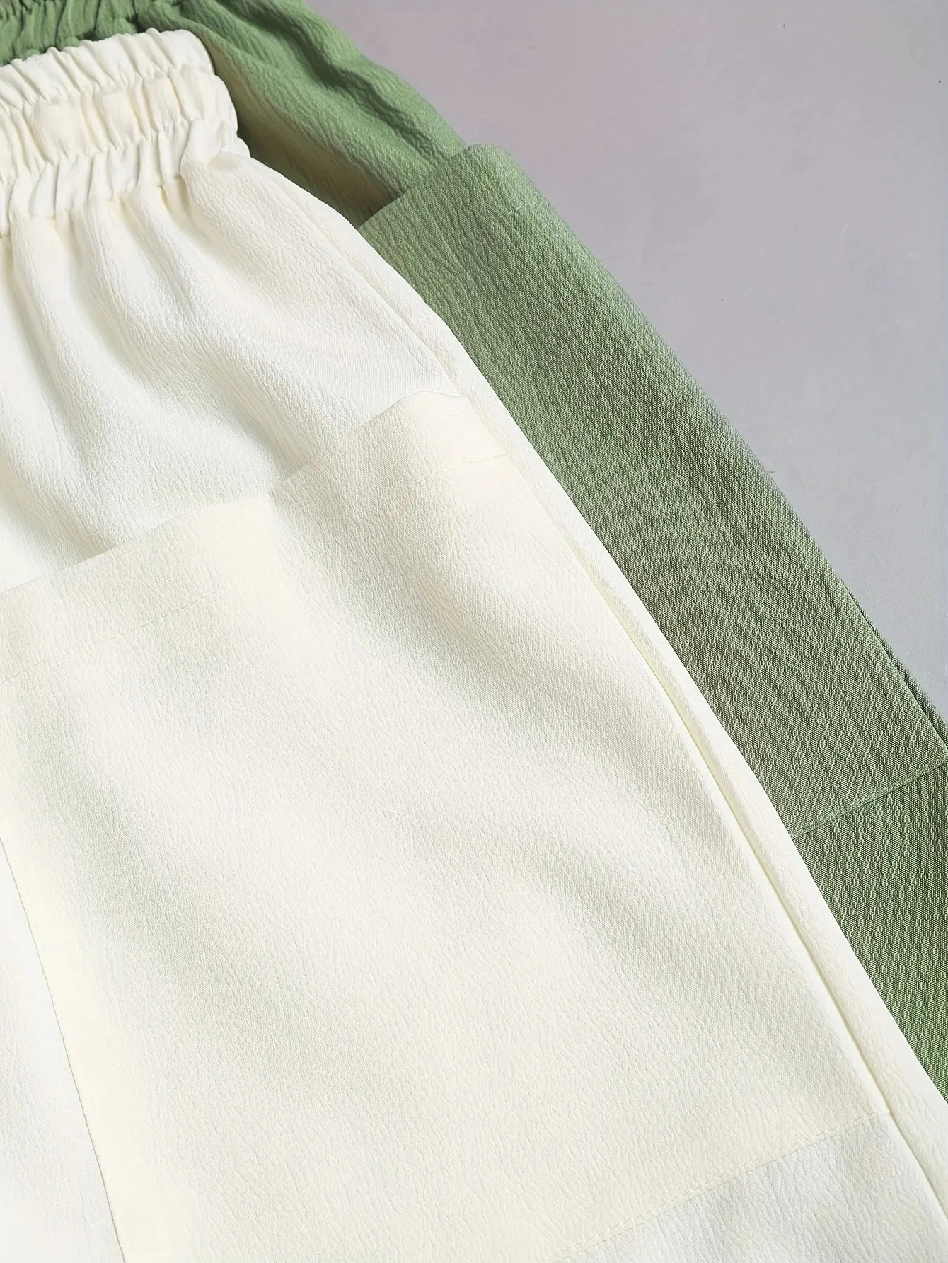 A 2-piece set of solid color casual drawstring shorts with pocket beach pants for women in 2026