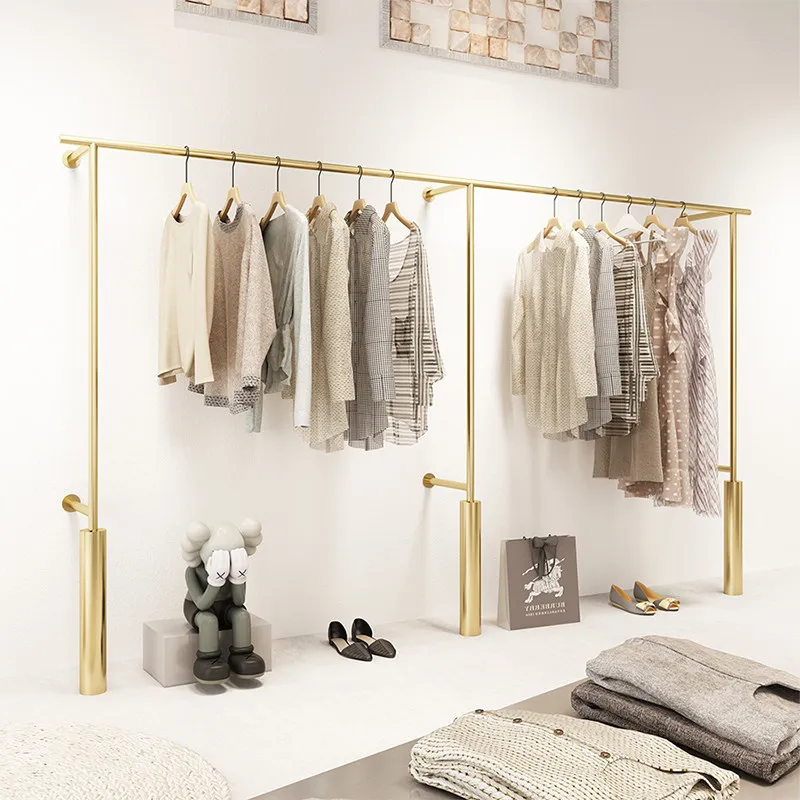 

Стеллажи для демонстрации одежды в магазине, настенные вешалки для одежды, золотые декоративные стеллажи для женской одежды.