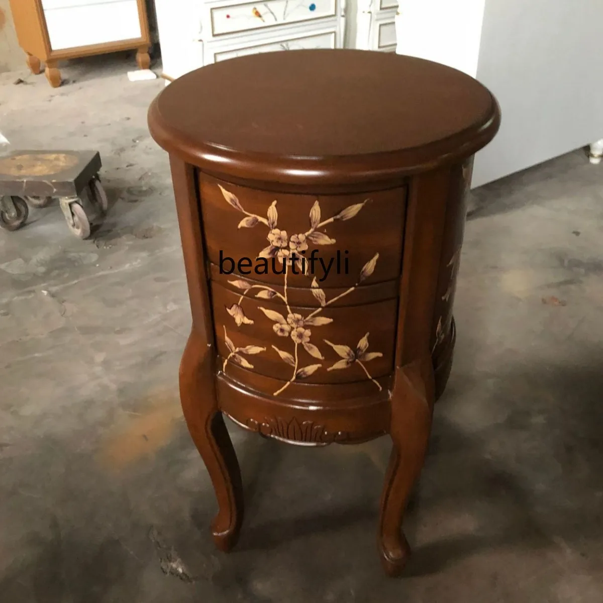 Round Table Several Piles of Gold Painted Furniture Two Chests Sofa Side Table