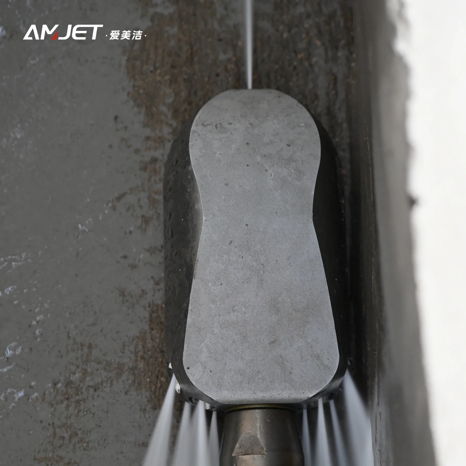 Amjet cleaning uses jet head connected to high pressure washer for use in cleaning trenches