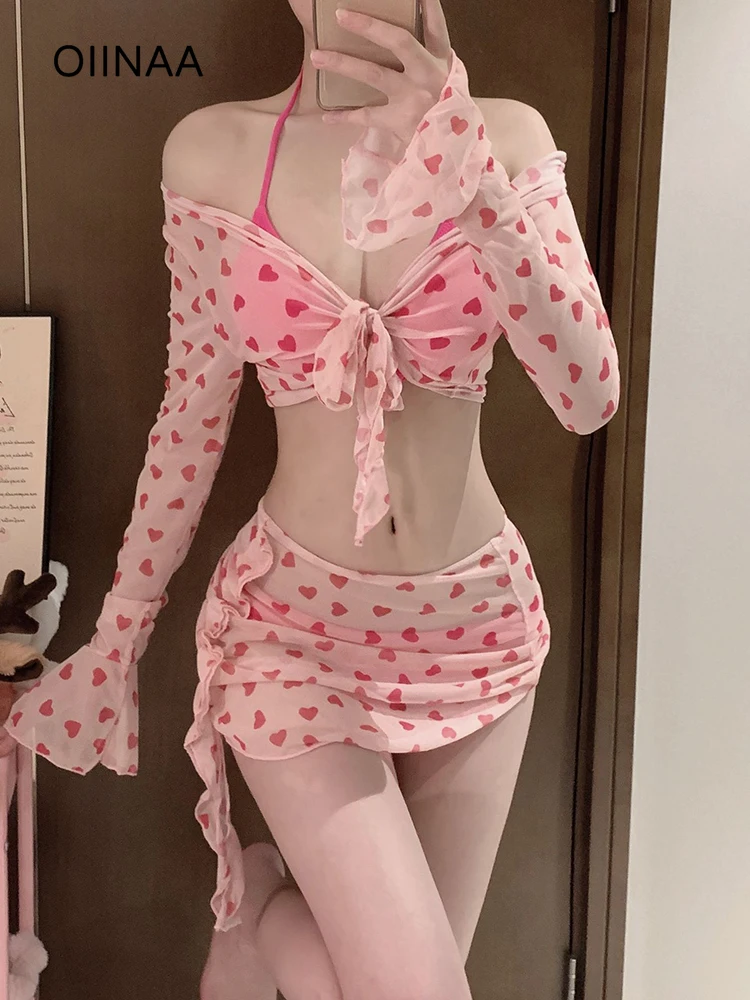 

OIINAA розовый купальник женский комплект бикини с принтом сердца с длинными рукавами и рюшами горячий весенний купальник лето 2025 новые накидки с запахом юбка
